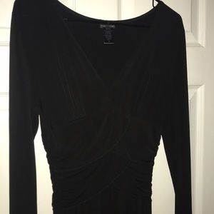 Black dress,deep v neck line and accentuates waist